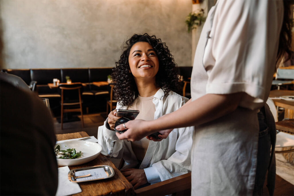 Woman paying the bills at a restaurant 2