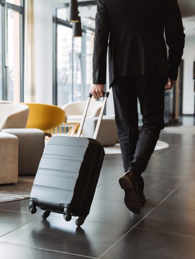 Man rolling his suitcase Man rolling his suitcase